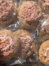 a bunch of cookies in plastic wrap with sprinkles on them