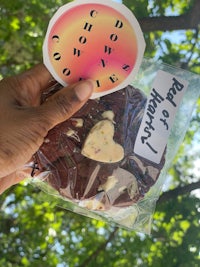 a person holding a bag of cookies with a sticker on it